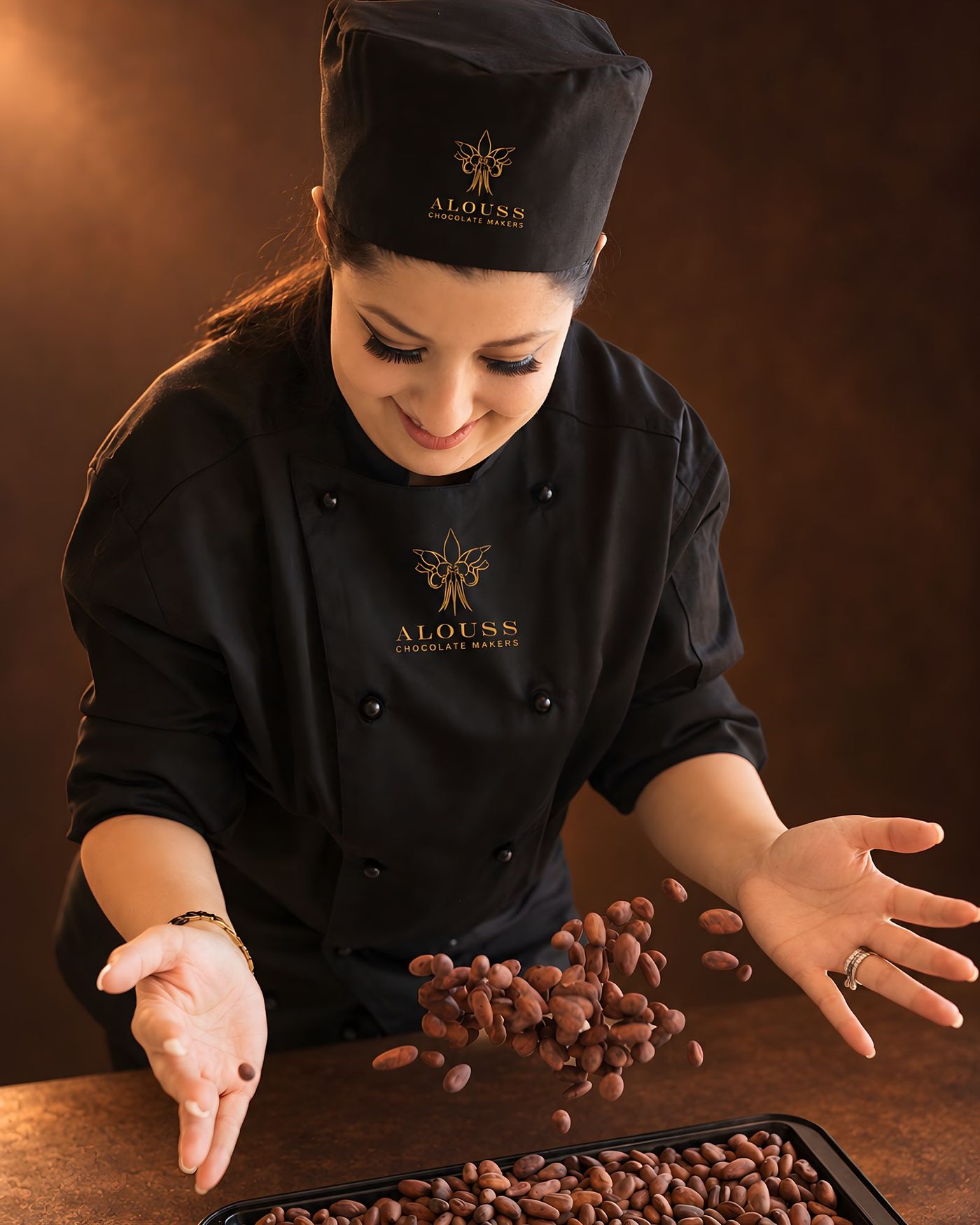 Founder Elsie in her chocolate whites, tossing roasted cocoa beans