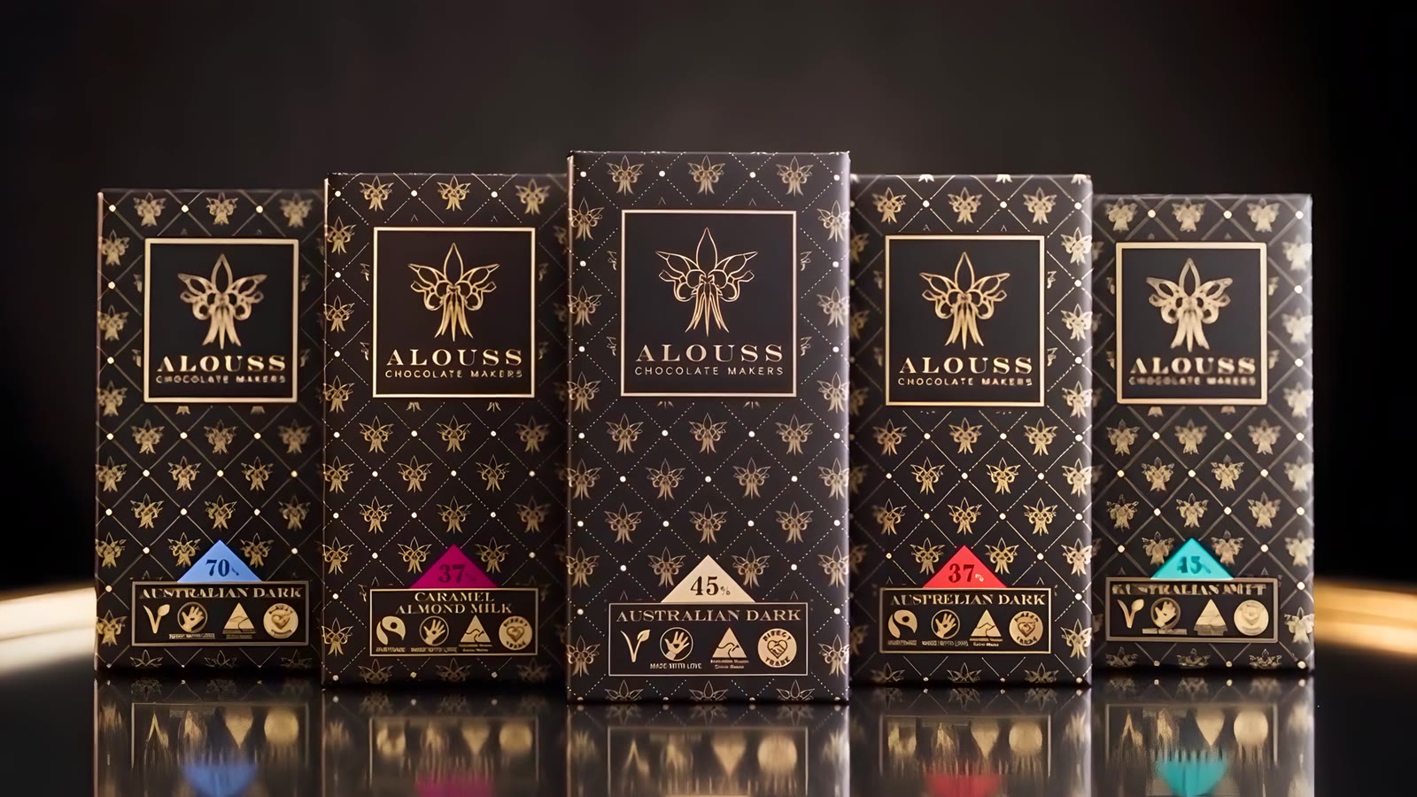 Seven Alouss chocolate bars in black and gold packaging standing in a fan